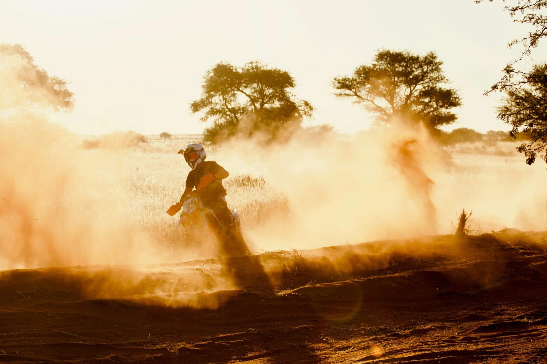 Motorcycle riding through the Moroccan desert at golden hour